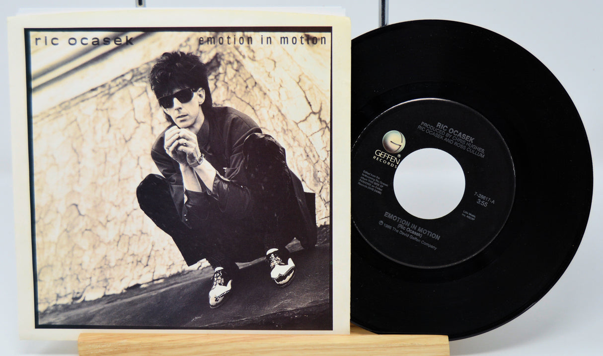 Vinyl record with cover featuring a person against a textured wall