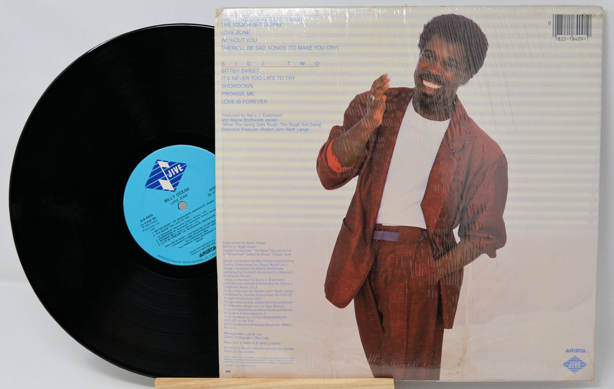 Vinyl record with a person on the cover and a visible label.
