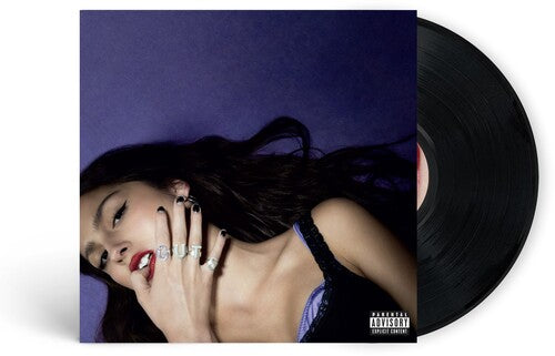 This image features the vinyl record of Olivia Rodrigo's album "Guts." The vinyl itself is depicted in a clean, clear condition, highlighting the album's title and artist name in a subtle manner.