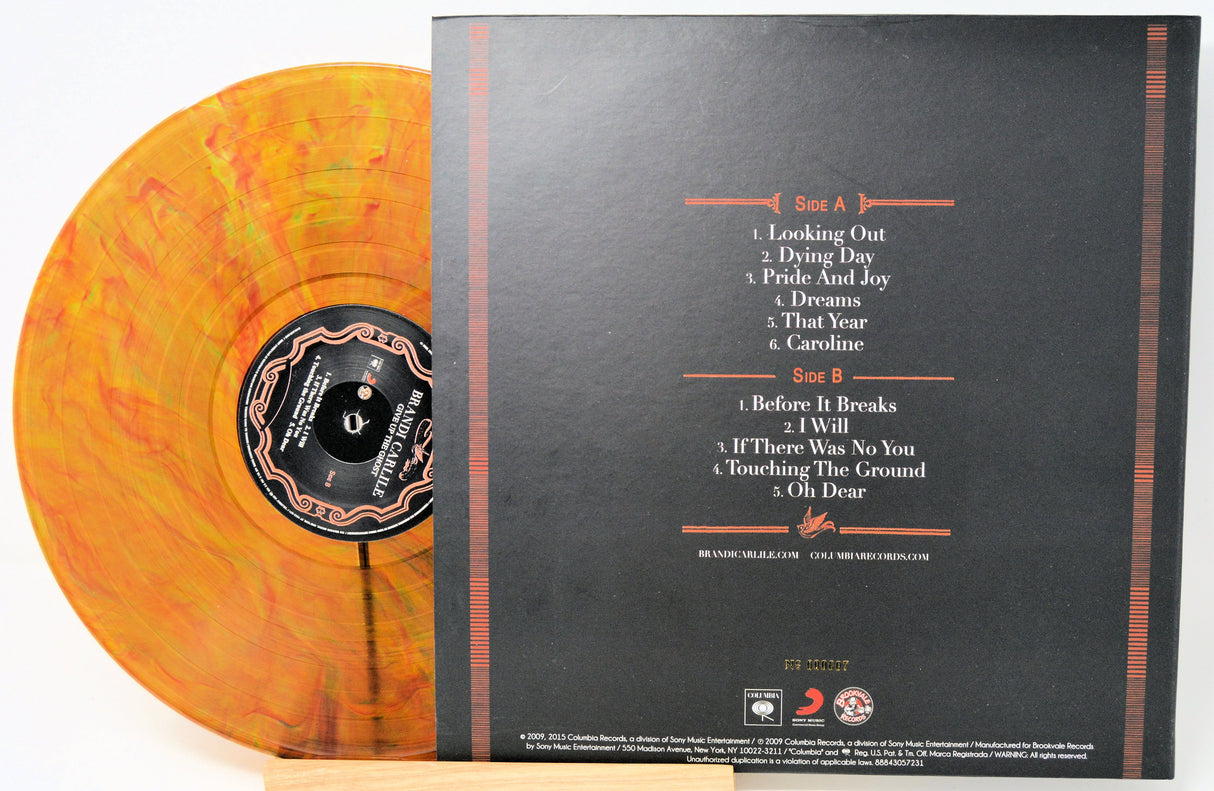 Orange swirl vinyl record with rear album cover showing tracklist
