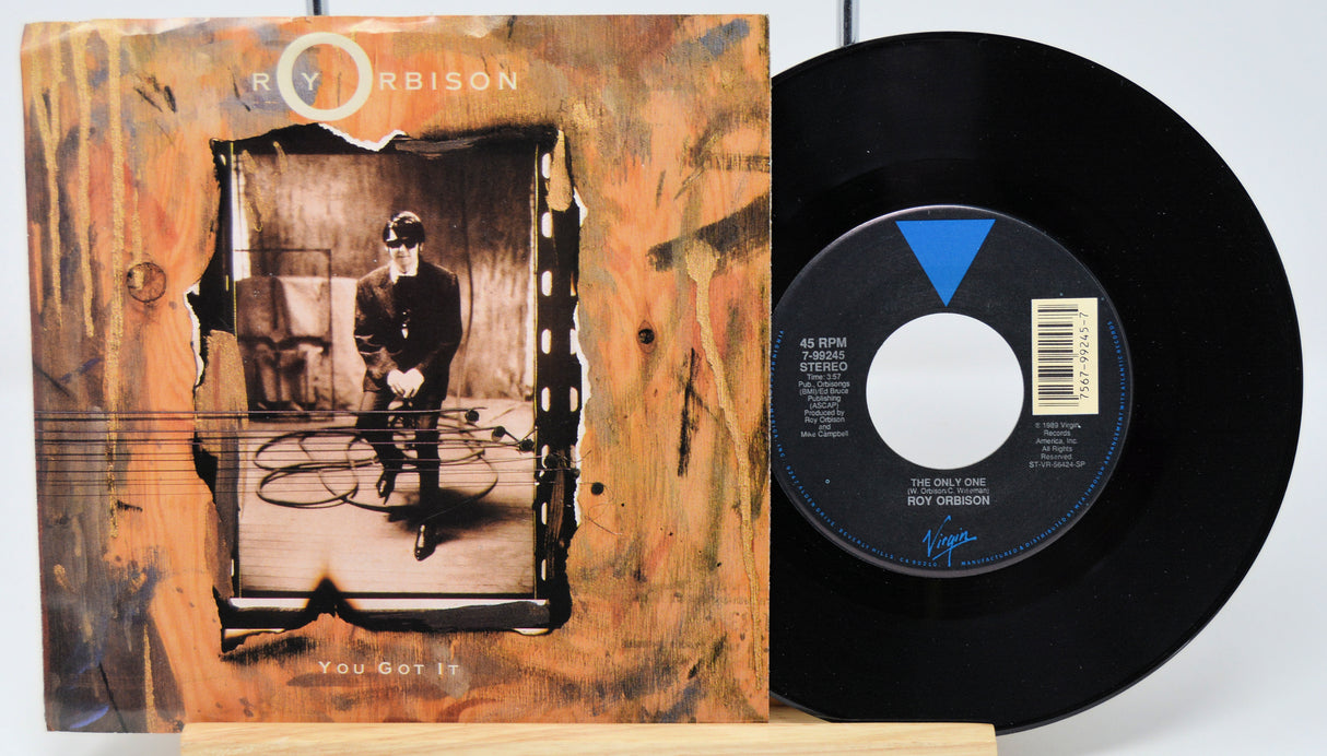 Vinyl record with cover featuring a person playing guitar, on a white background