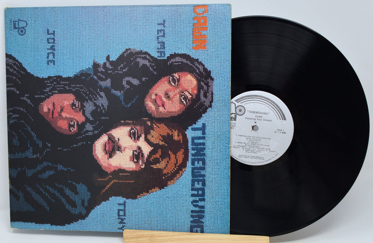 Vinyl record with a pixelated cover featuring three faces and text.