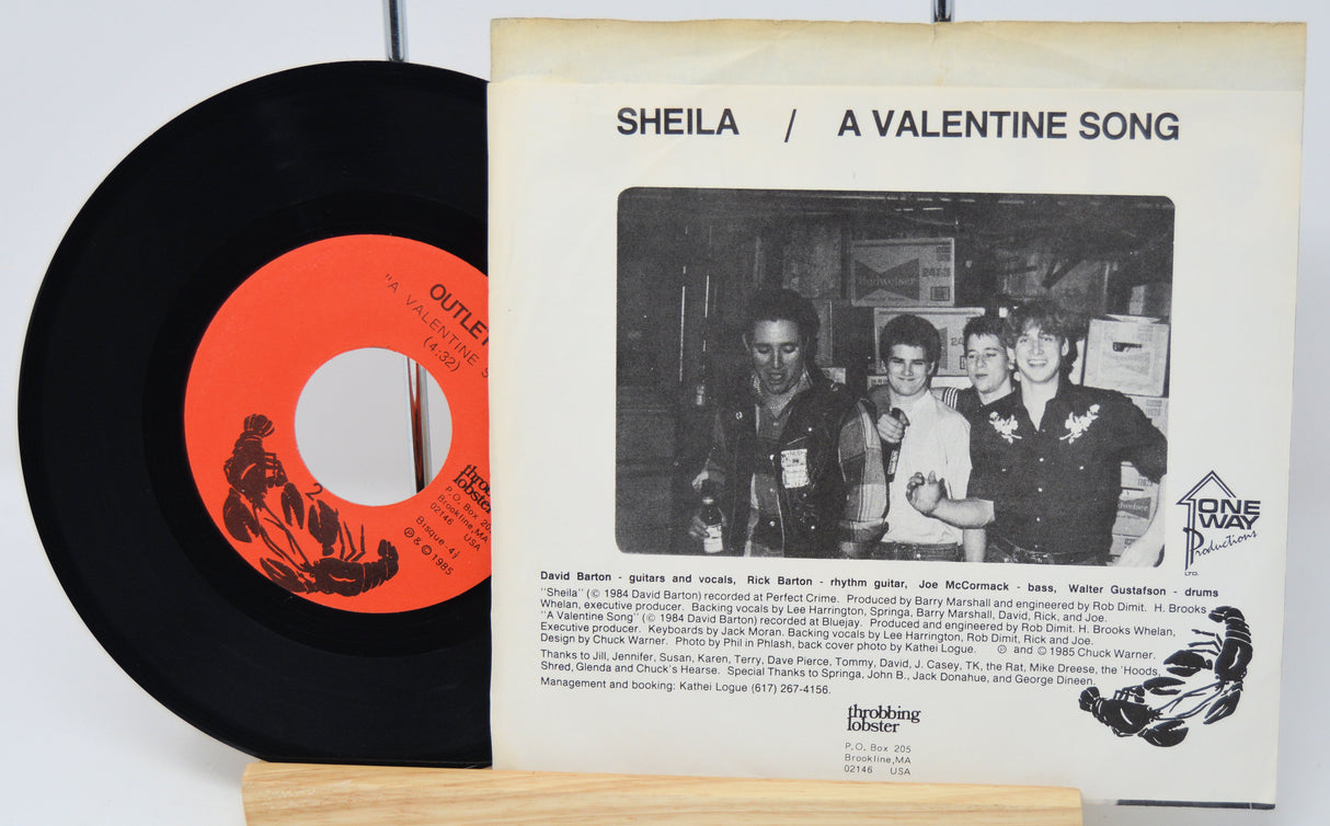 Vinyl record with red label and cover featuring a black and white photo of people.