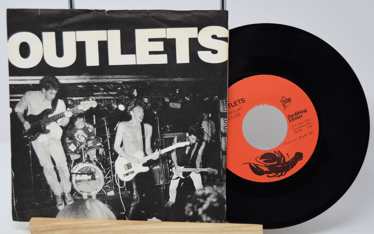 Vinyl record with cover featuring a band and lobster illustration on a white background