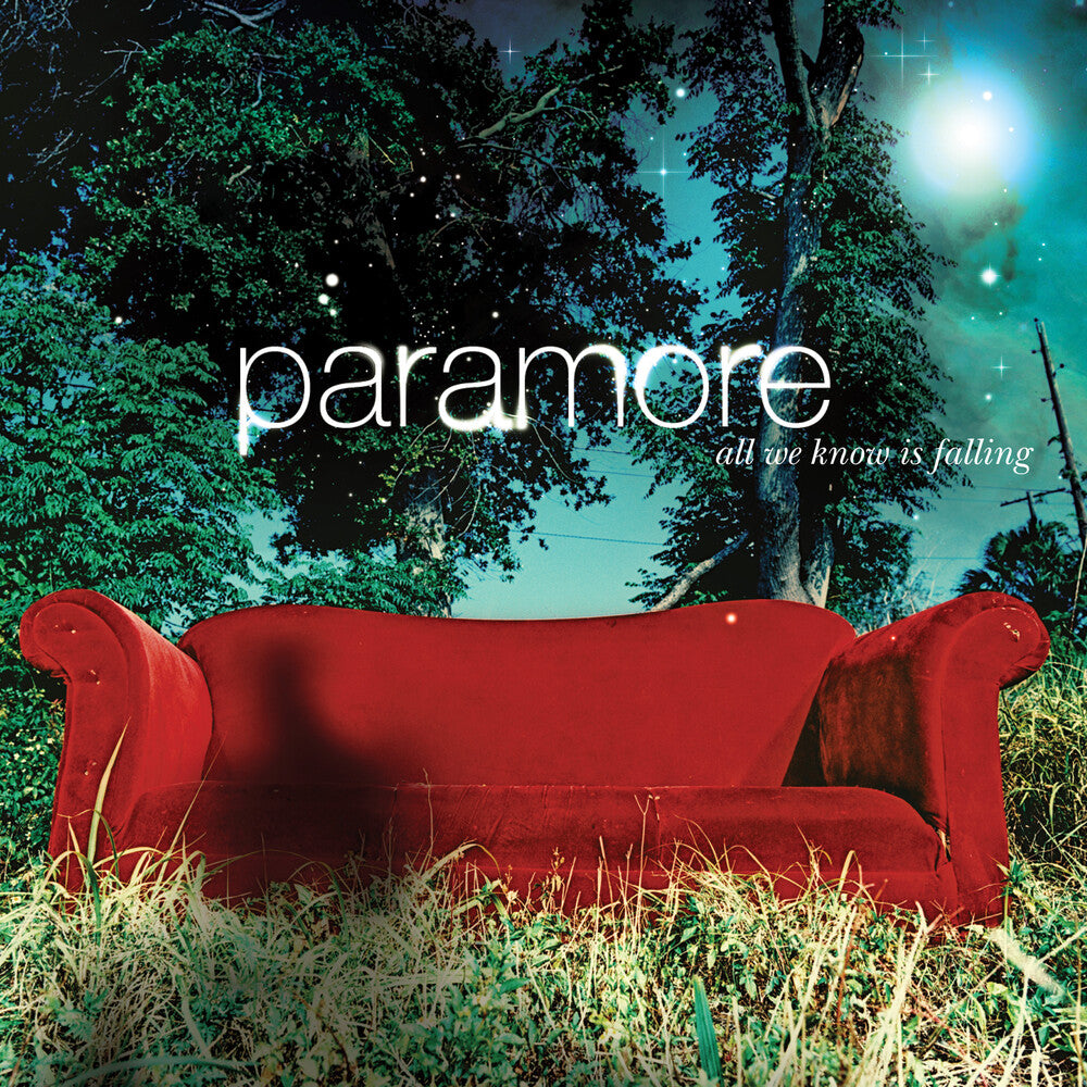 Album cover for Paramore's 'All We Know Is Falling' with a red couch in a forest setting.
