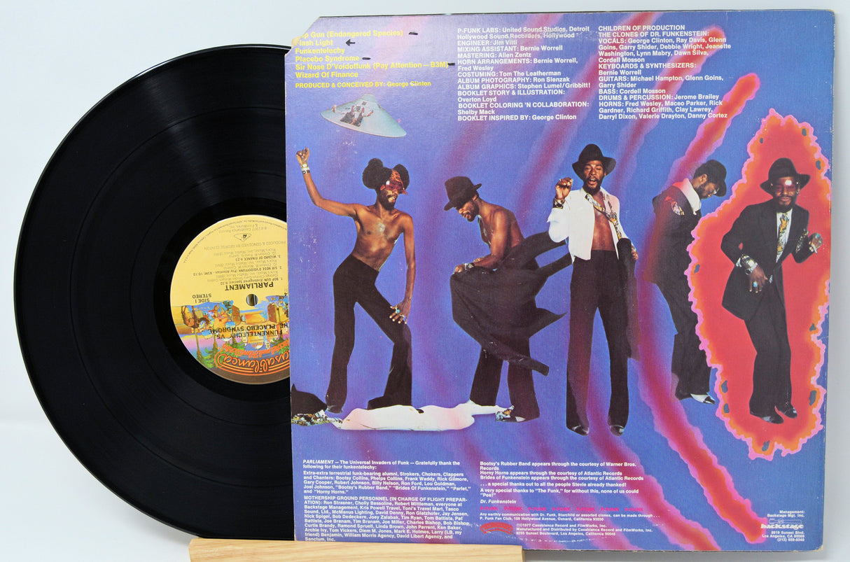 Back cover of Parliament Funkentelechy Vs. The Placebo Syndrome vinyl LP featuring band members in funky outfits