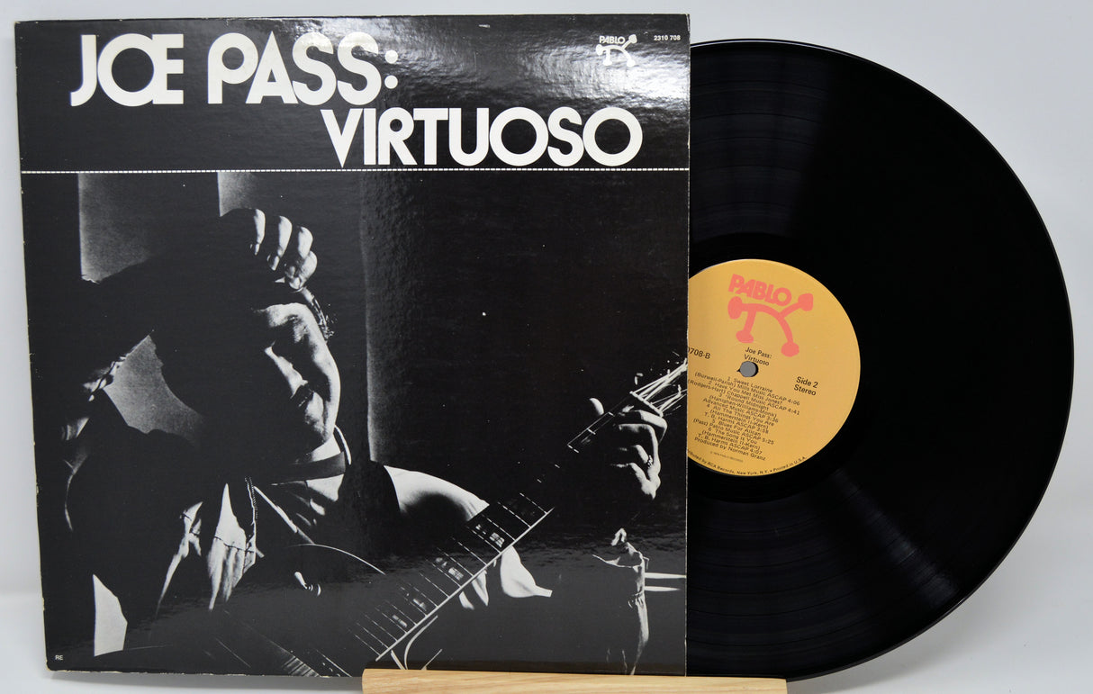 Vinyl record and cover titled 'Virtuoso' by Joe Pass on a white background