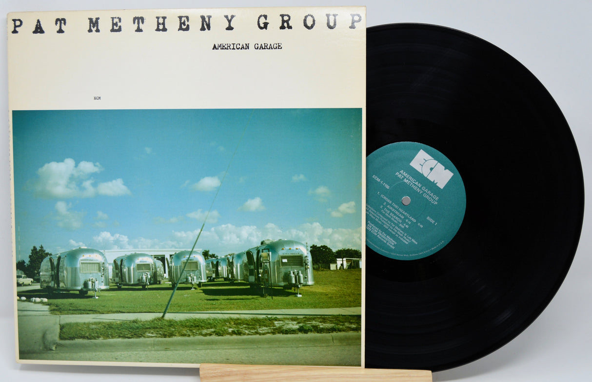 Vinyl record with cover featuring 'Pat Metheny Group' and 'American Garage' on a white background