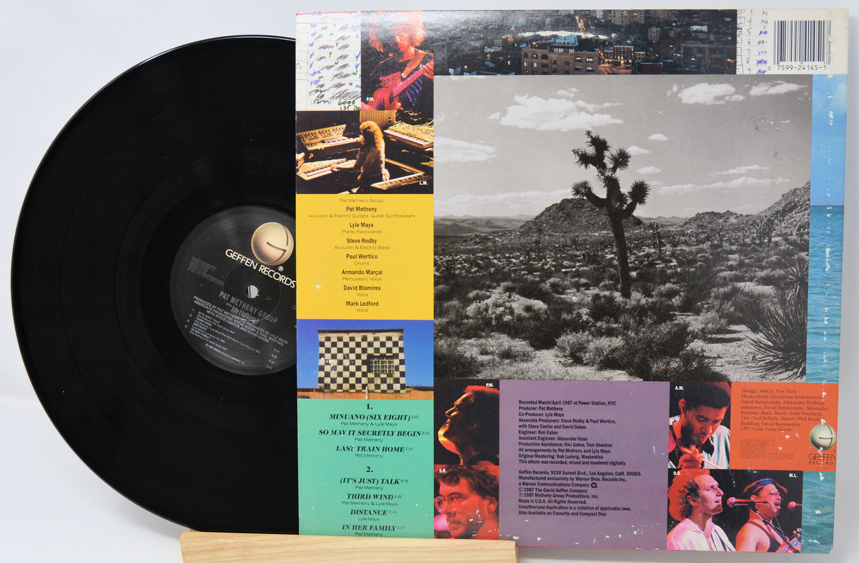 Vinyl record with a cover featuring a person in a grand hall.