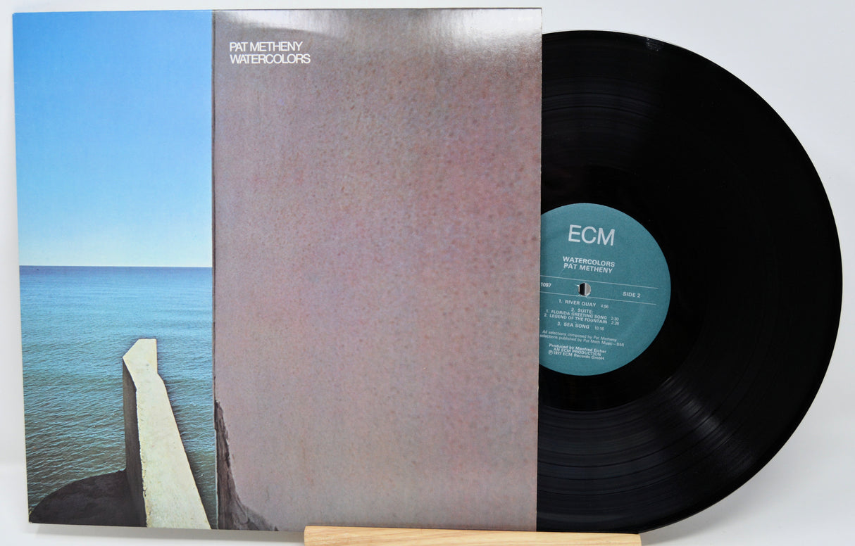 Vinyl record with cover showing a coastal scene and ECM label