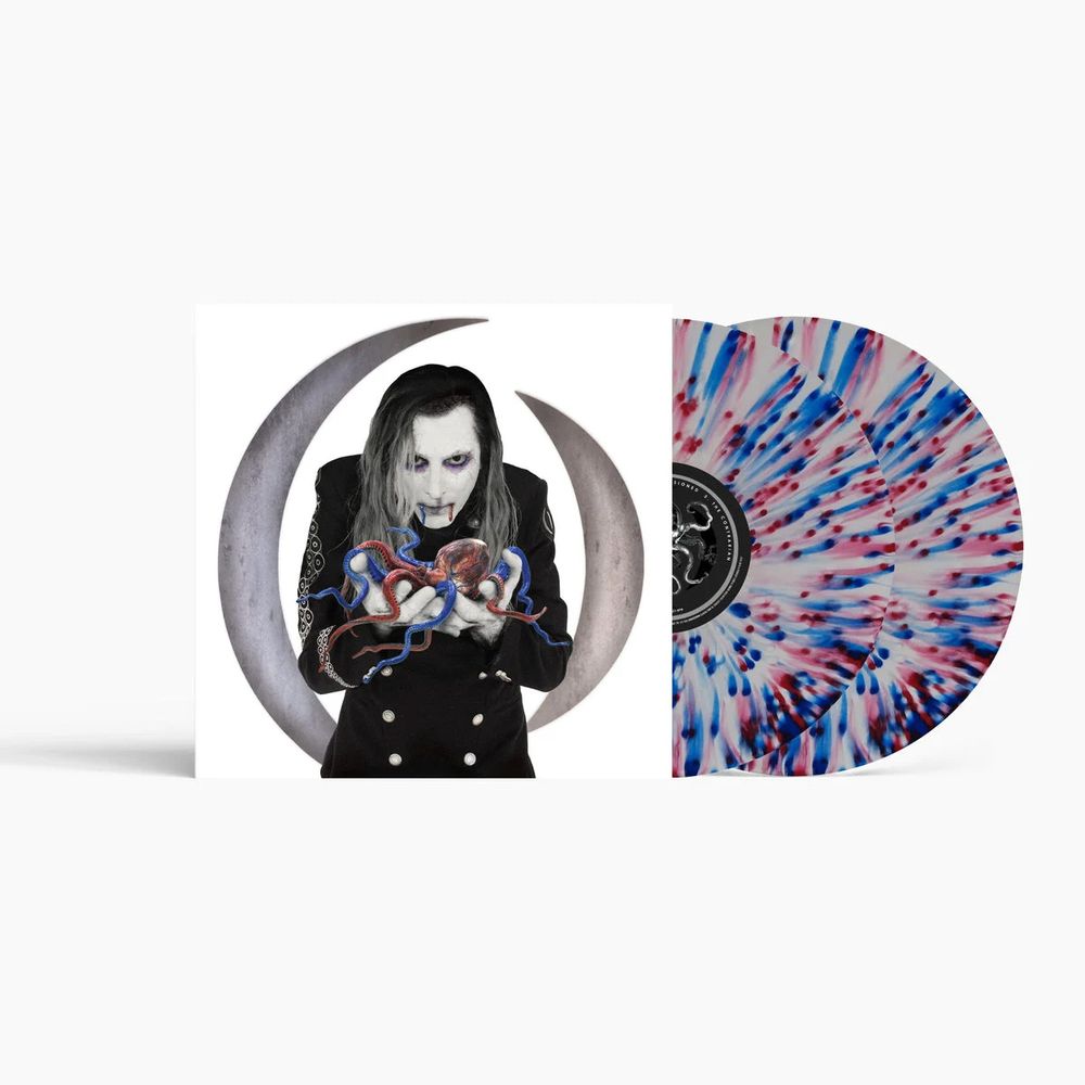 A vinyl record package shown on a light gray background, featuring a printed cover with a portrait of a pale figure in front of a crescent moon holding a heart-shaped object, next to a translucent record sleeve with a red, white, and blue burst pattern.