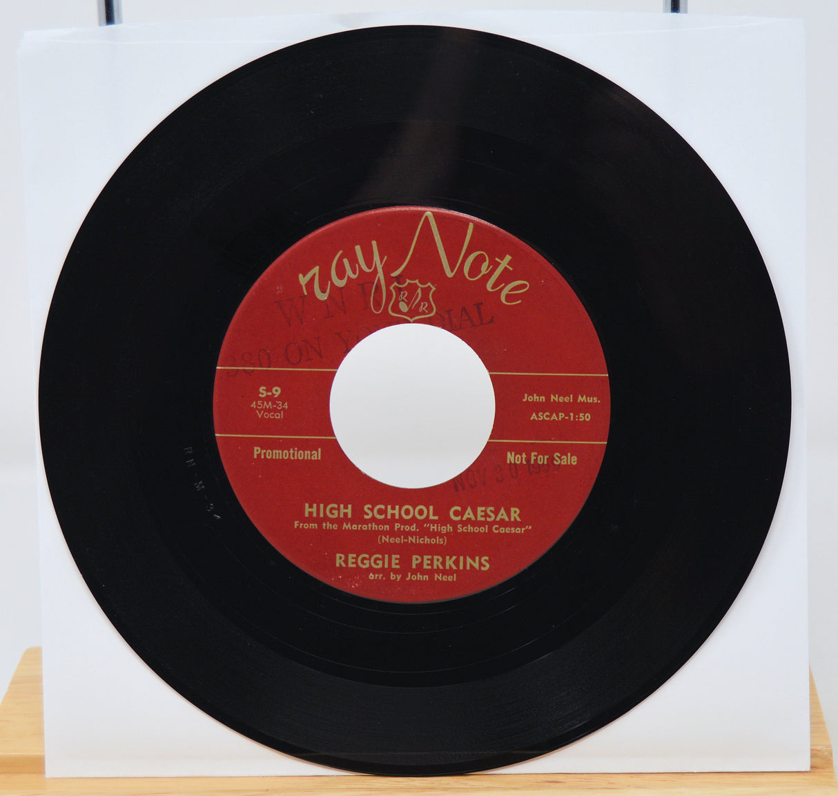 7-inch vinyl record with red label on a white background
