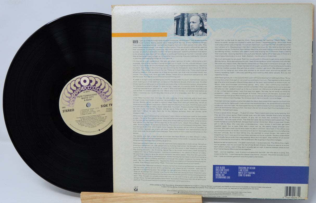 Vinyl record with cover featuring text and a portrait on a light gray background