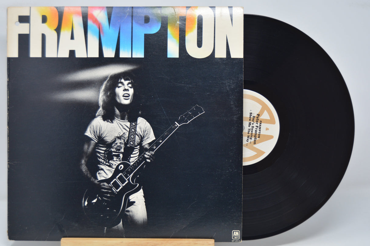 Vinyl record with a cover featuring a person playing guitar, titled 'Frampton'.