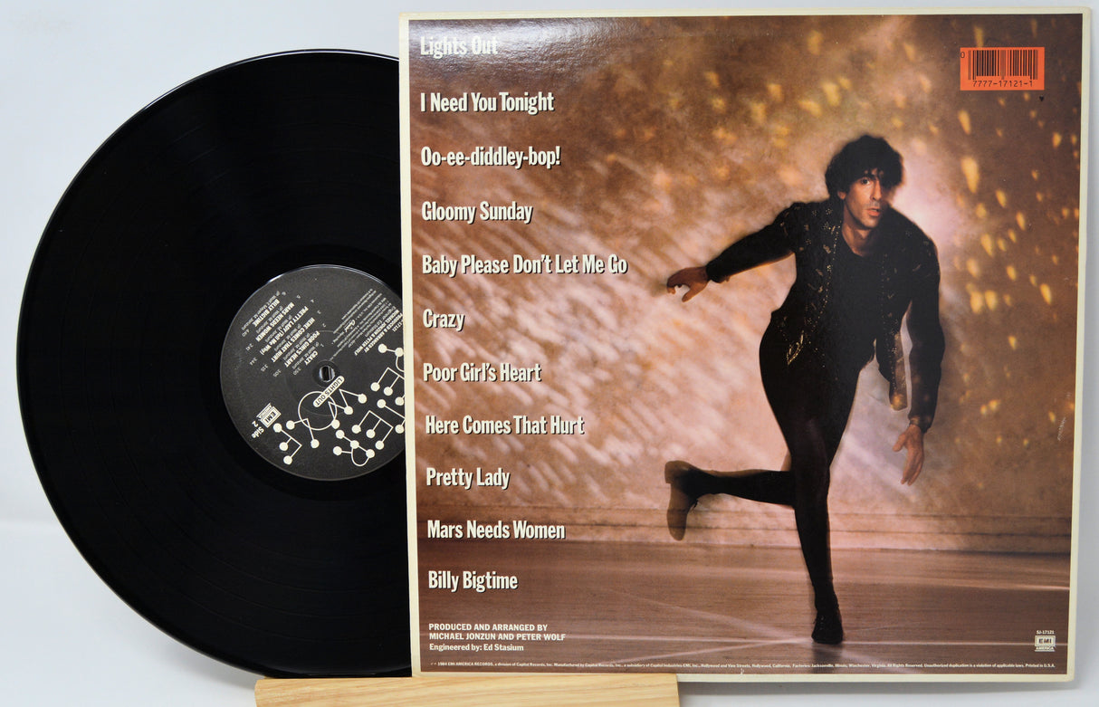 Vinyl record with yellow label featuring a photo of a person playing guitar and text.