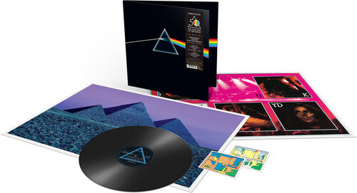 Pink Floyd - Dark Side Of The Moon (50th) The image shows the 50th anniversary edition vinyl record of Pink Floyd's 'Dark Side of the Moon' album with the gatefold jacket, posters, and stickers.