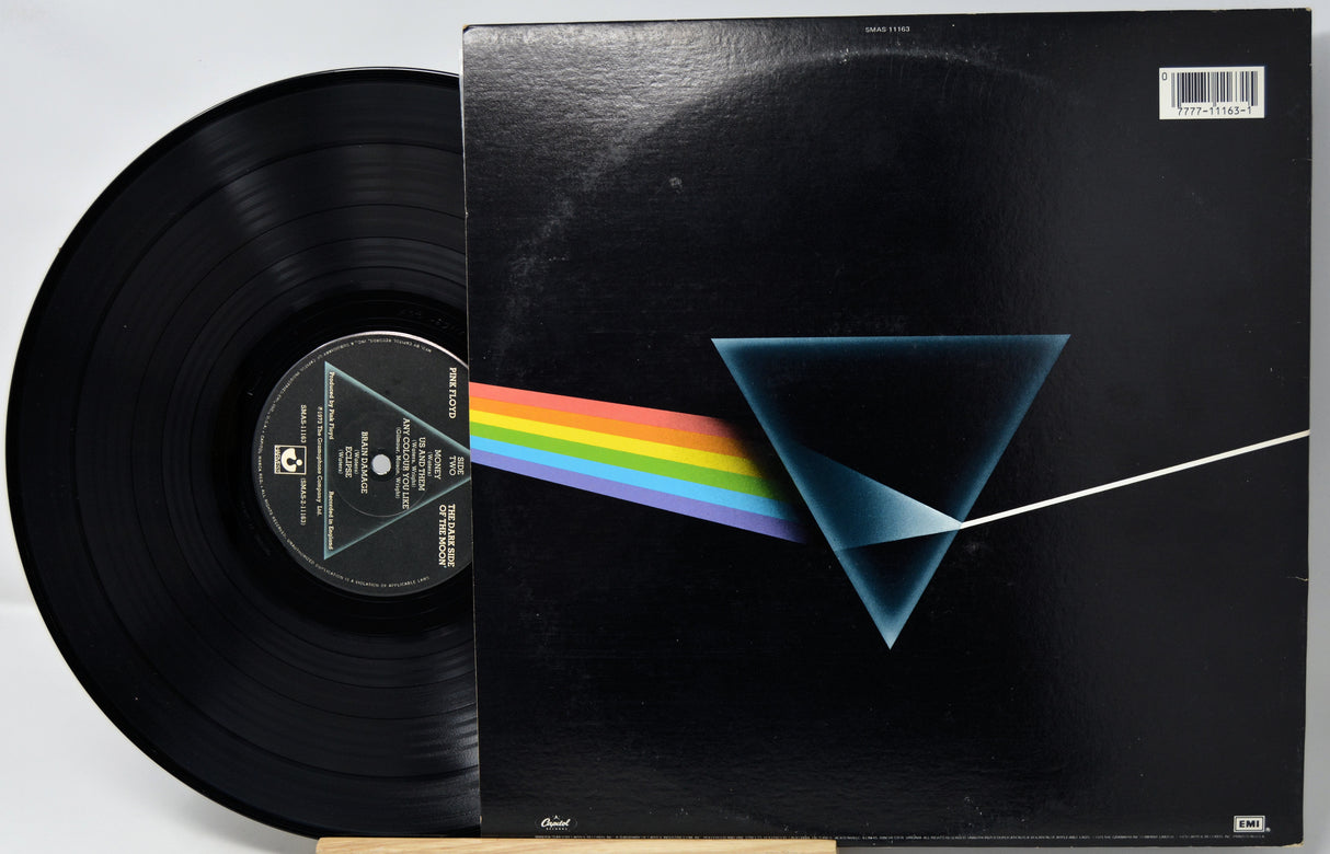 Vinyl record with cover featuring a rainbow and triangle design on a black background