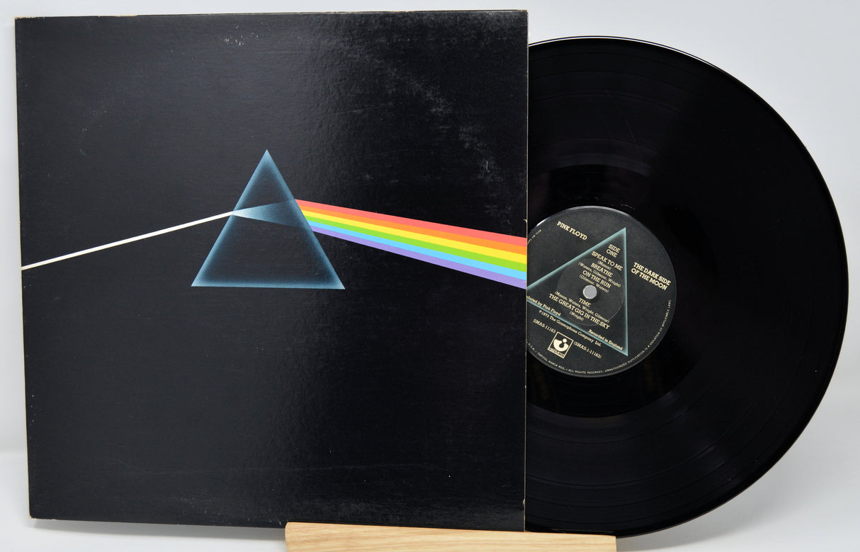 Vinyl record with 'The Dark Side of the Moon' album cover featuring a triangle and rainbow.