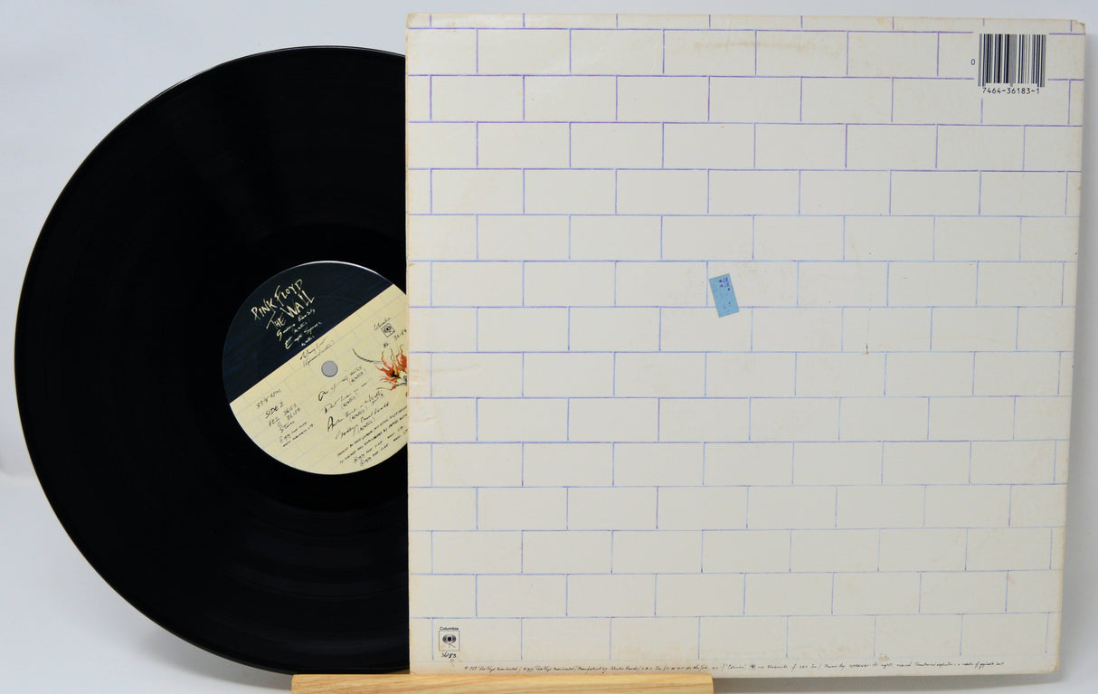 Vinyl record with a white cover featuring a tiled pattern