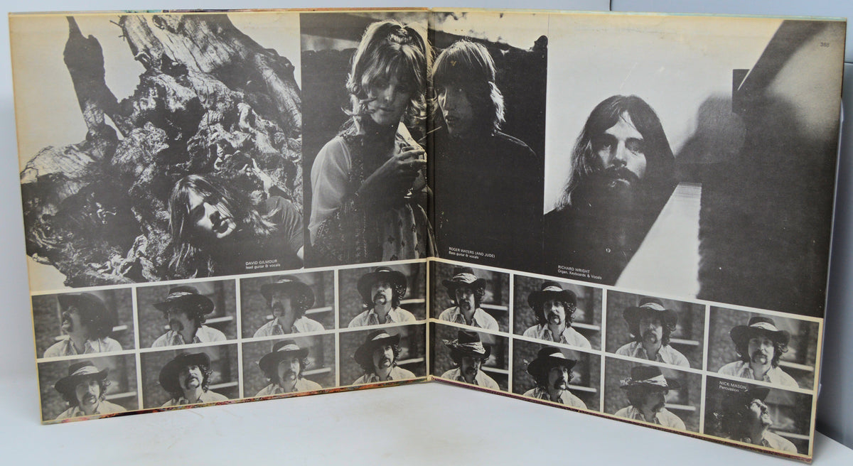 An open vintage photo album or binder showing multiple black-and-white portrait photographs arranged in a collage layout, photographed against a light neutral background.
