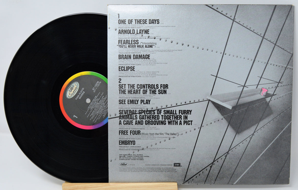 Vinyl record with cover featuring a person by a waterfront, on a white background