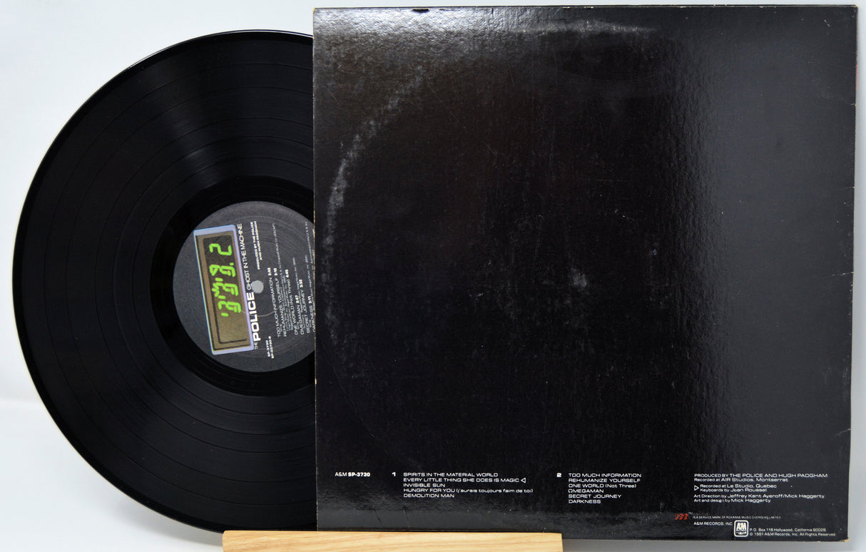 Black vinyl record with a visible label and matching black record cover on a white background