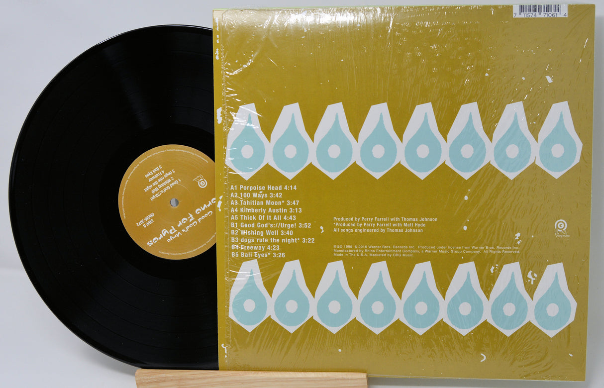 Vinyl record with a yellow cover featuring blue geometric patterns on a light gray background
