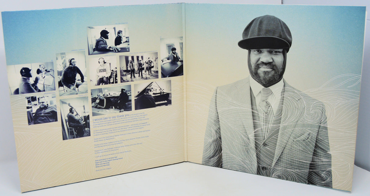 Open book or album with a portrait of a man on one page and black and white photos on the other.