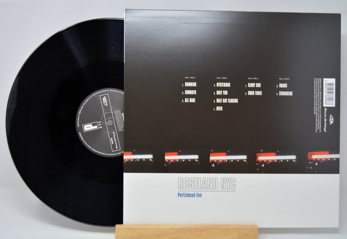 Vinyl record 'Portishead - Roseland NYC Live' with back cover displaying track listings on a white background
