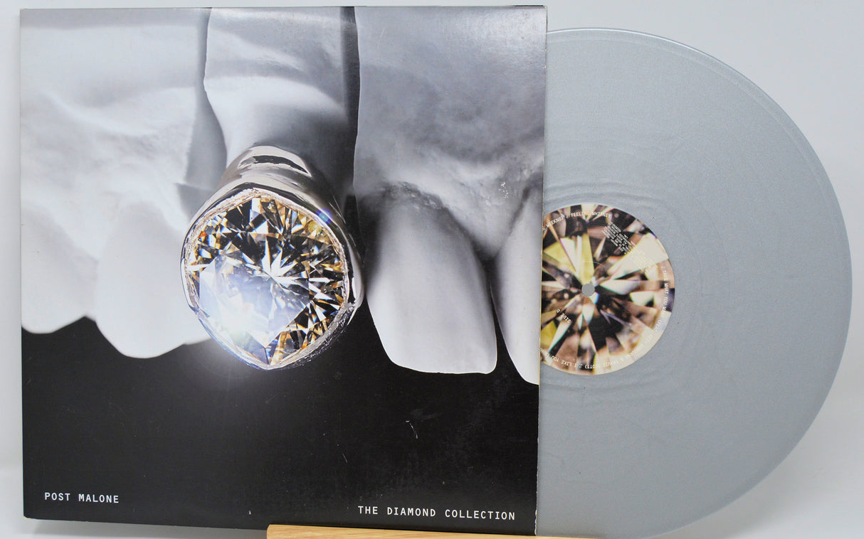 Front cover of Post Malone The Diamond Collection vinyl with large diamond tooth close-up and silver record