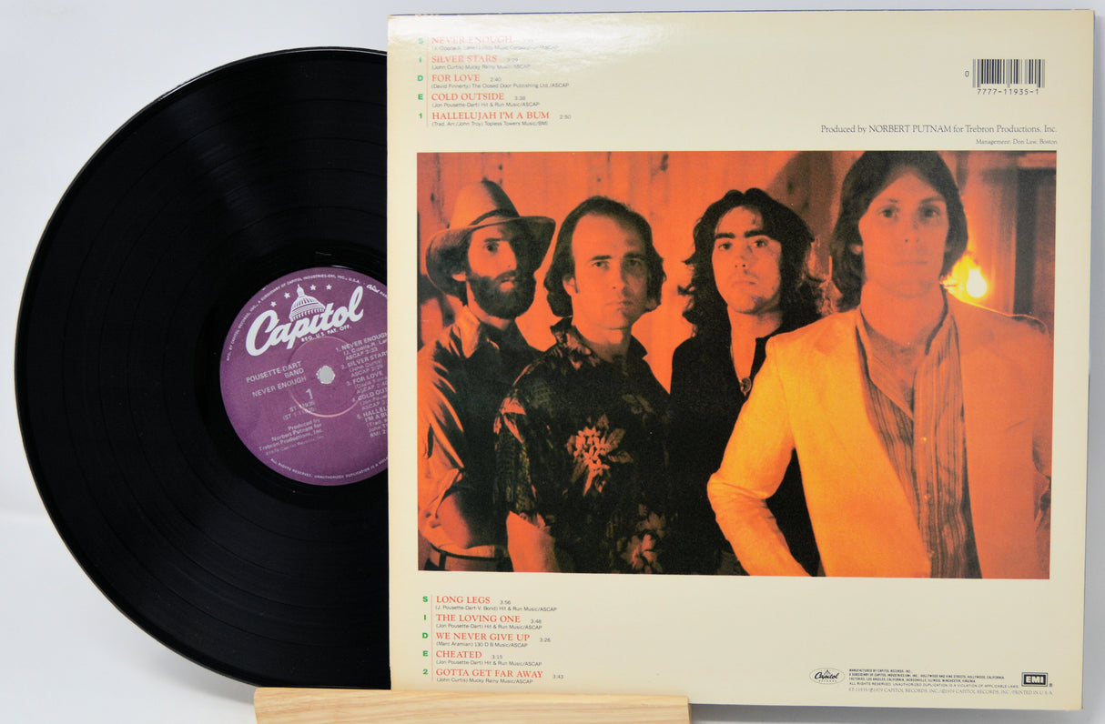 Vinyl record with a Capitol label and a cover featuring four band members.