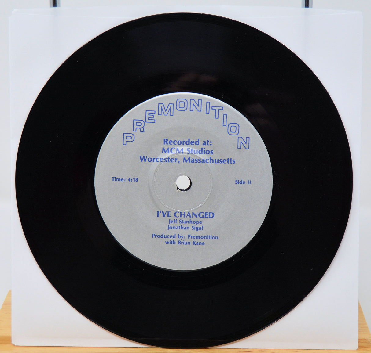 Vinyl record with a white label on a white background featuing I've changed