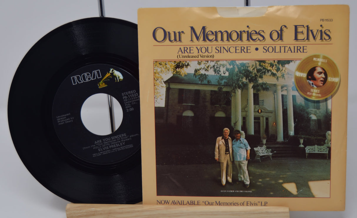 Vinyl record and its cover titled 'Our Memories of Elvis' on a white background