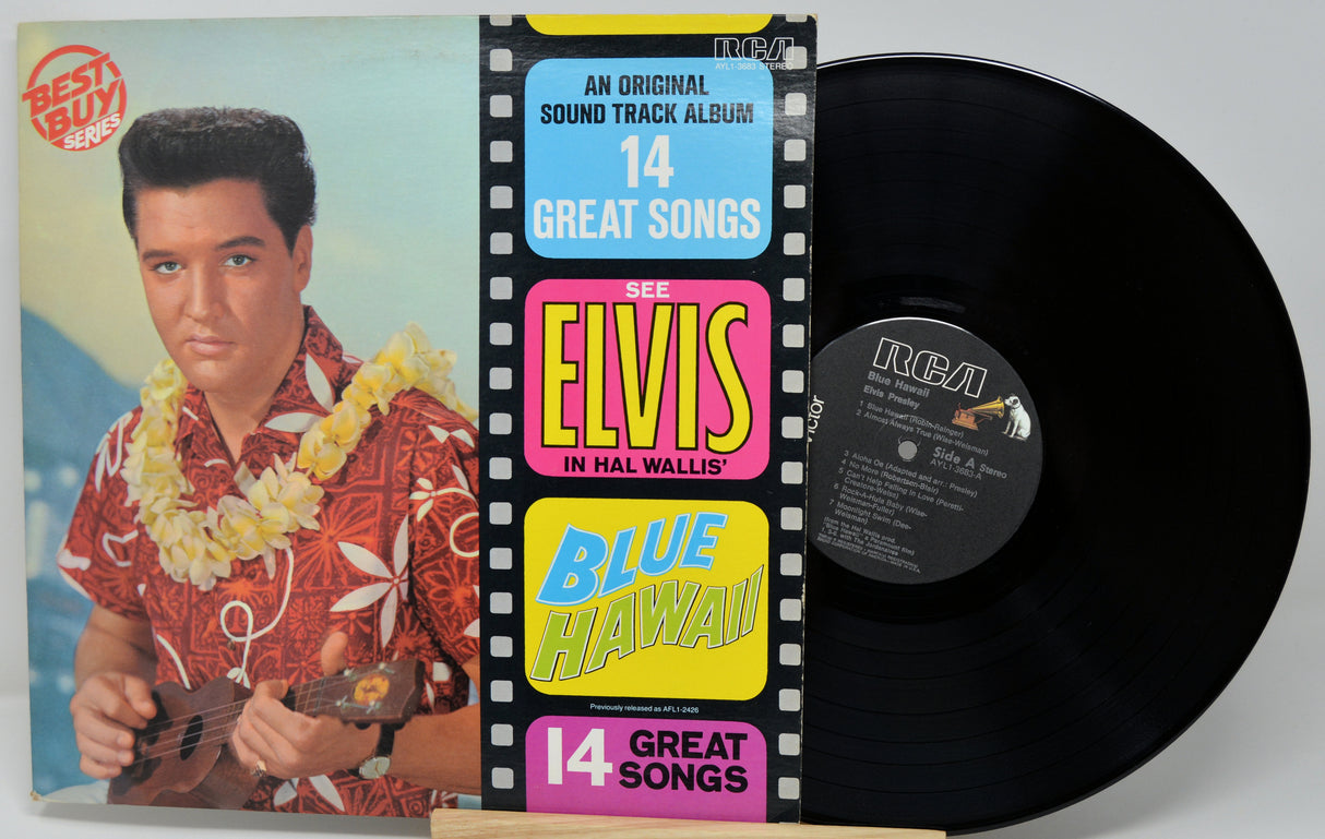 Vinyl record with cover featuring Elvis Presley and 'Blue Hawaii' album details.