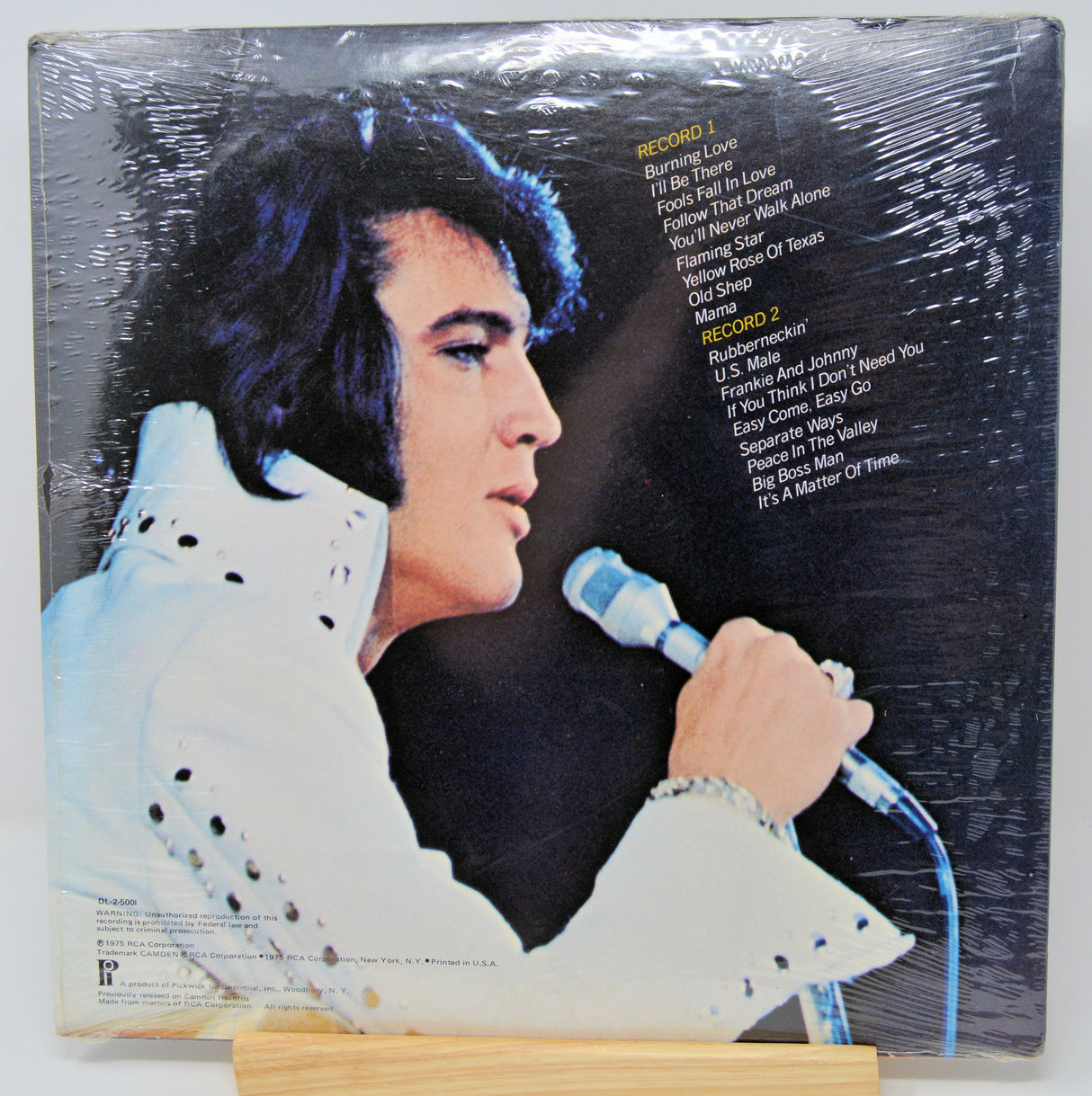 Vinyl record sleeve with a portrait of a person holding a microphone on a textured background
