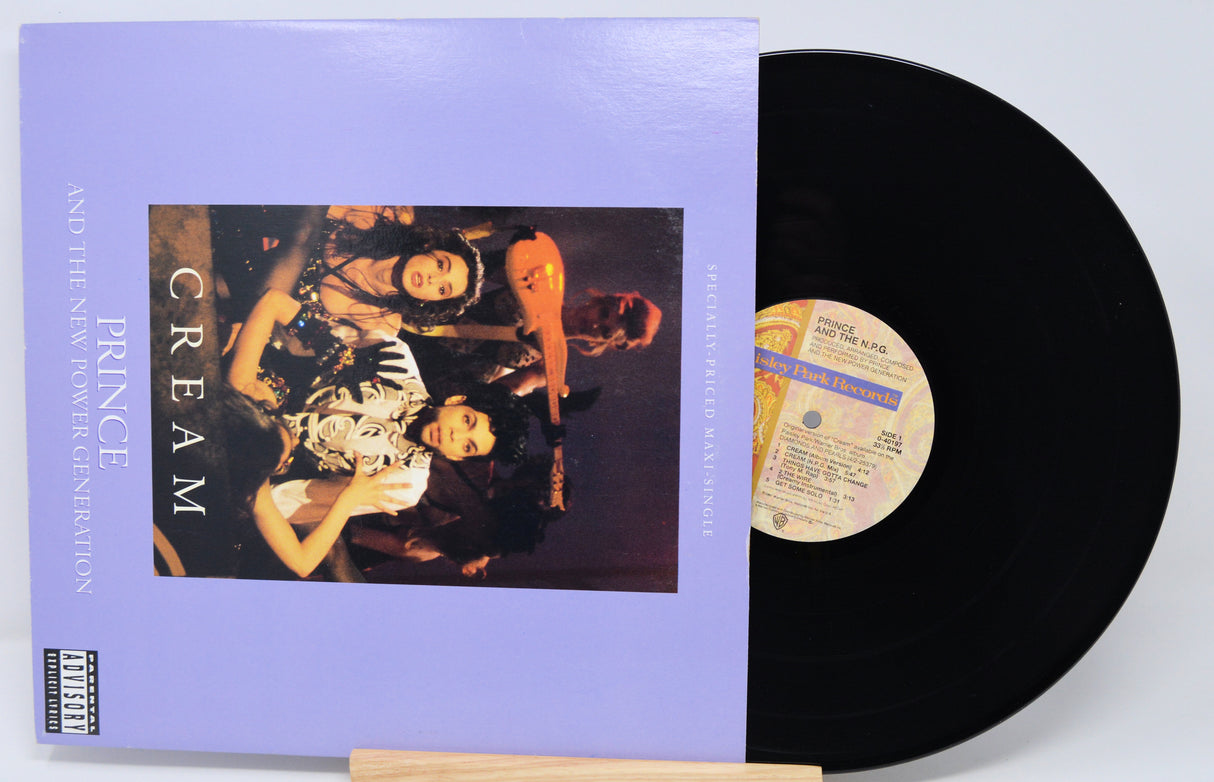 Vinyl record with a purple cover featuring an album cover of Prince and a woman, on a white background.