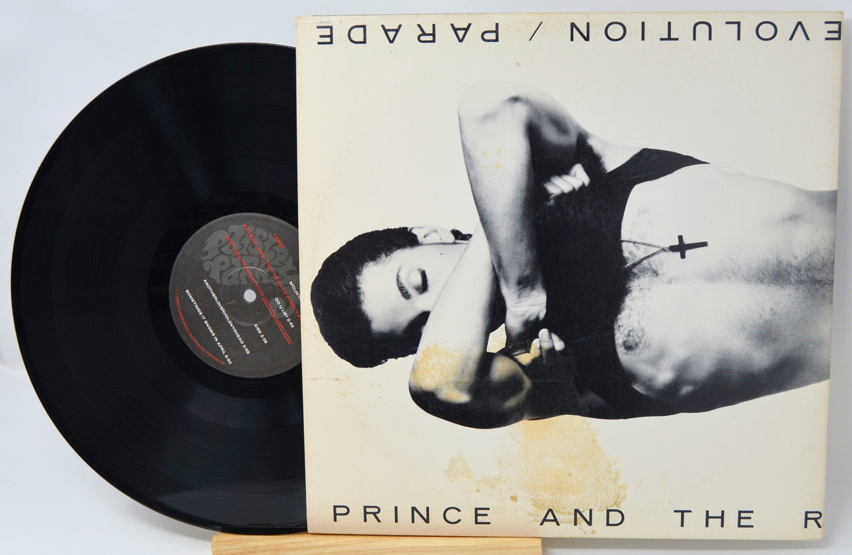 Parade album front cover featuring Prince and The Revolution with vinyl partially visible
