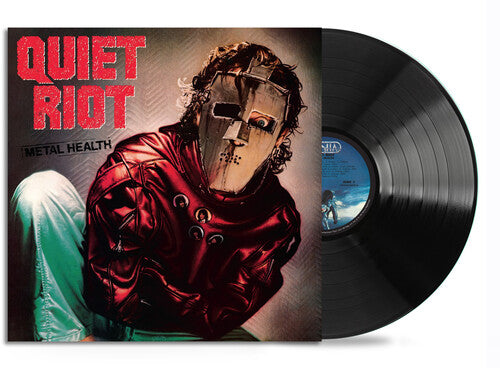 Vinyl record with 'Quiet Riot' album cover featuring a person in a red outfit and helmet.