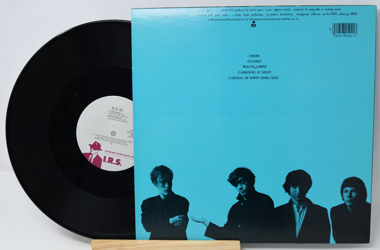 Vinyl record with a blue cover featuring black silhouette images of four people.
