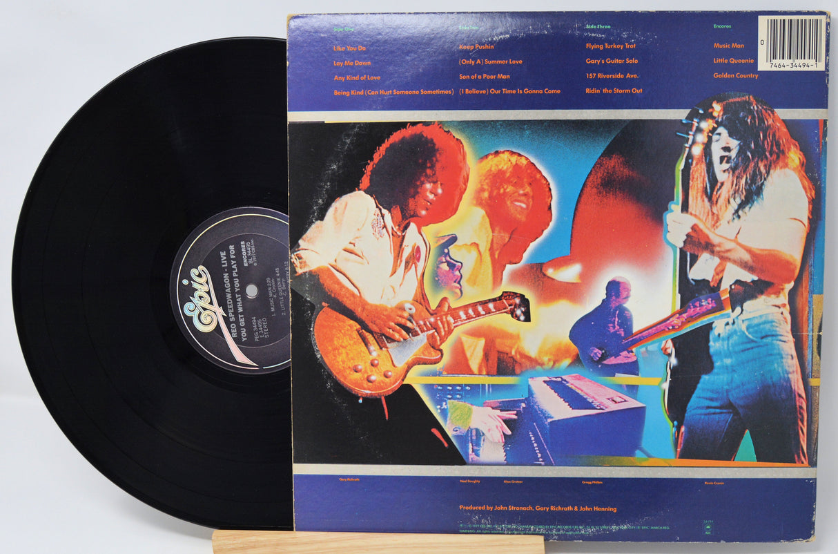 Vinyl record with colorful cover featuring musicians and text