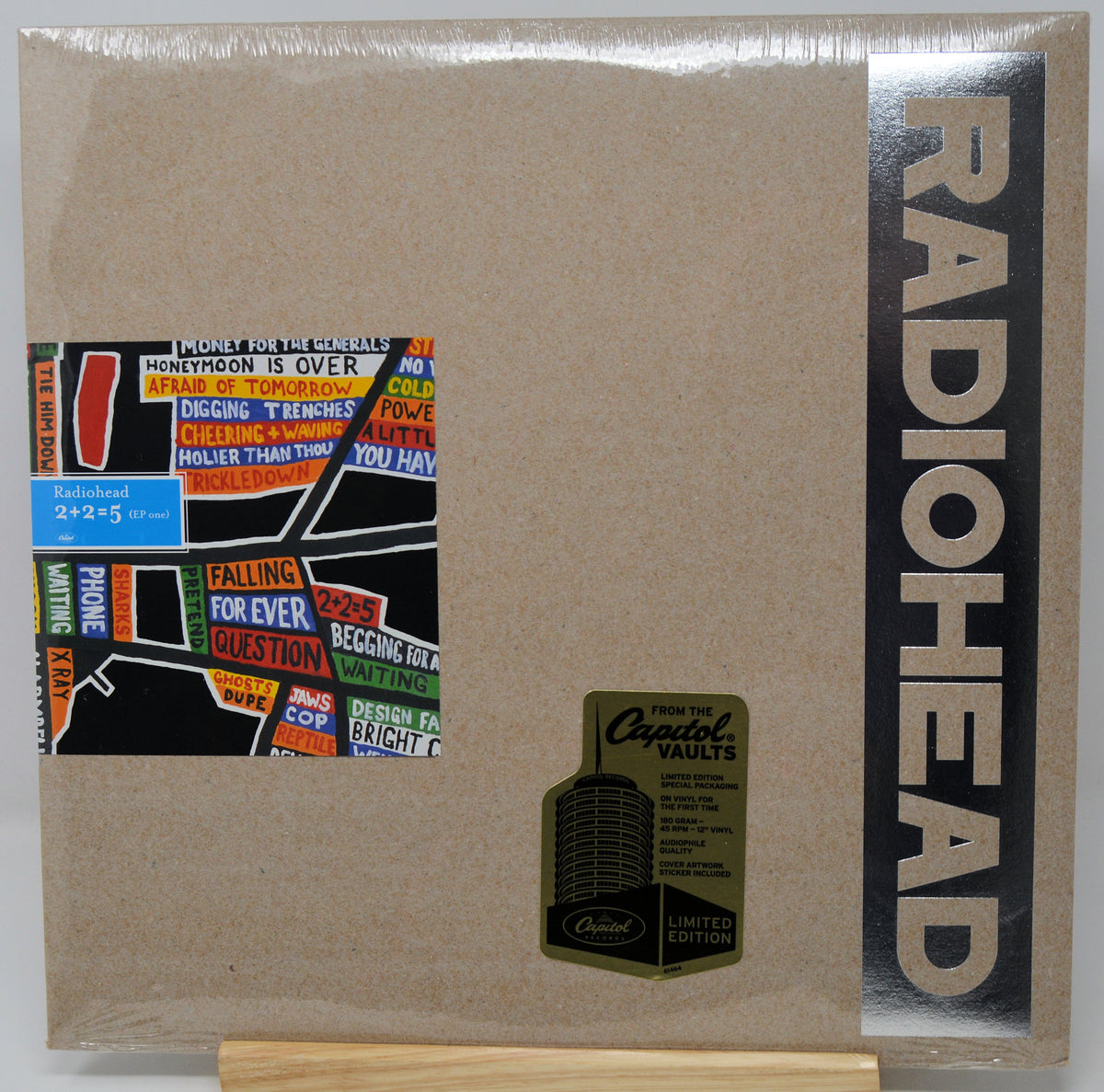 Radiohead 'From the Crystal Vaults' limited edition CD jewel case, sealed in plastic shrink wrap. The cover is a textured light brown/kraft paper style with a black vertical band on the right featuring the band name 'RADIOHEAD' in beige.