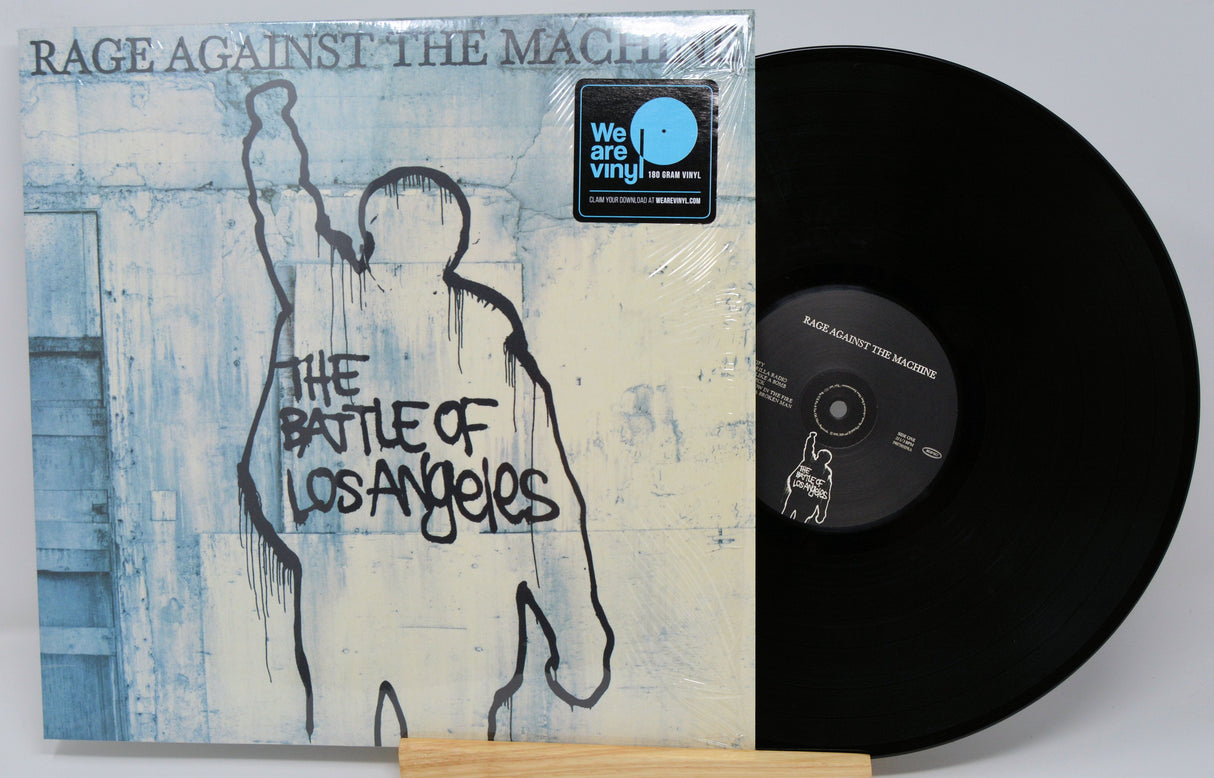 Front cover of Rage Against the Machine's The Battle of Los Angeles album with vinyl record, iconic silhouette artwork
