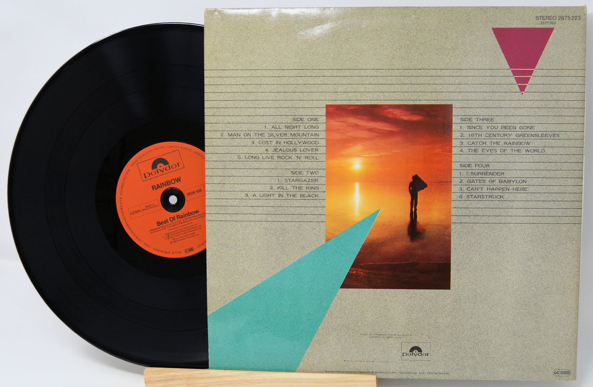 Vinyl record with a colorful album cover featuring a sunset and geometric shapes.