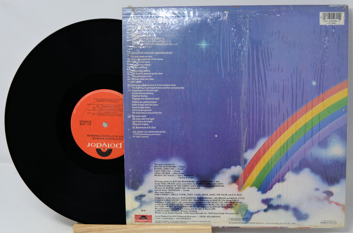 Vinyl record with colorful cover featuring a rainbow and starry sky design.