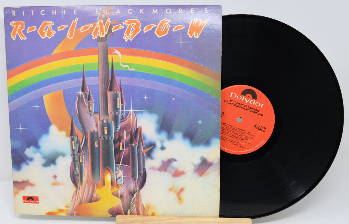 Vinyl record with cover featuring a colorful castle and rainbow, labeled 'R-A-I-N-D-O-W'.