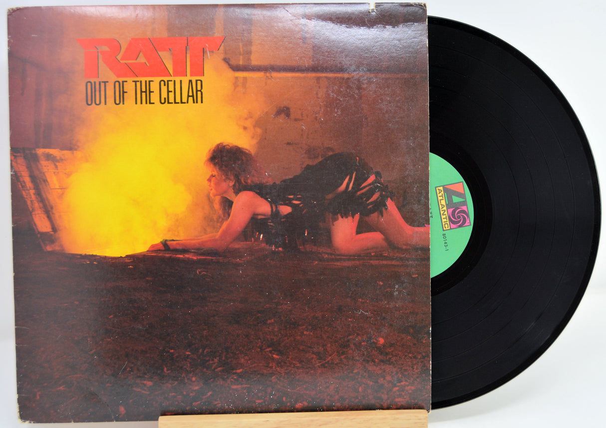 Vinyl record with 'Ratt Out of the Cellar' album cover showing a person lying on a bed.