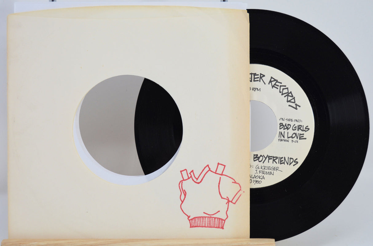 Red Sweater Records 7 inch vinyl single partially in a sleeve with red sweater illustration