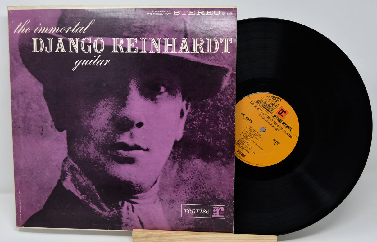 Vinyl record with cover featuring Django Reinhardt's portrait and album details.