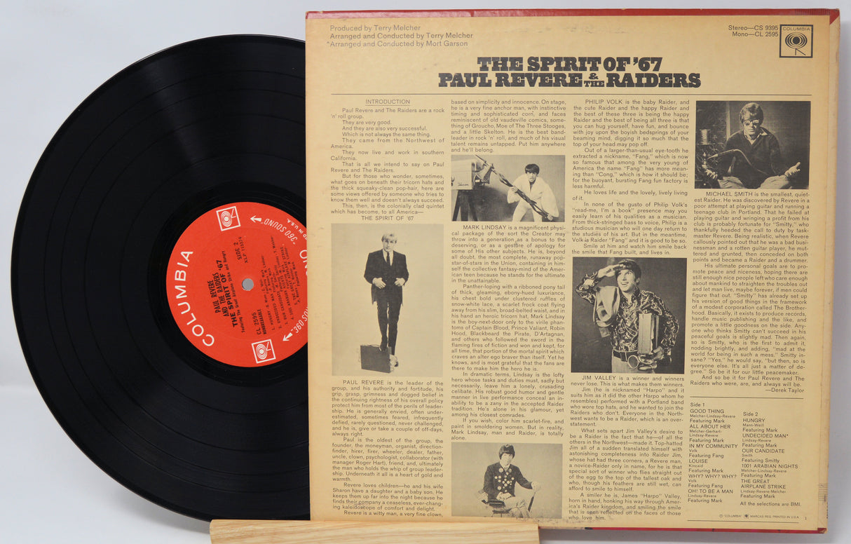 Vinyl record with a red label and its cover displaying text and images.
