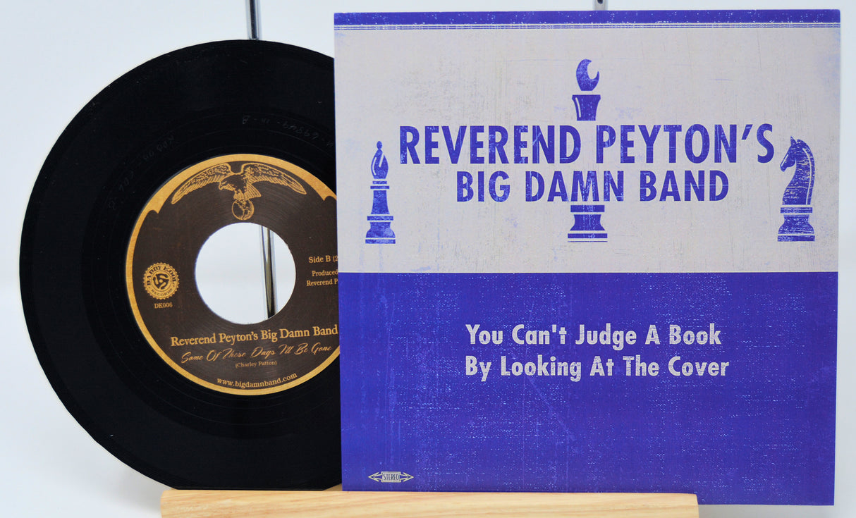 Vinyl record and cover of 'Reverend Peyton's Big Damn Band' with text on a white background